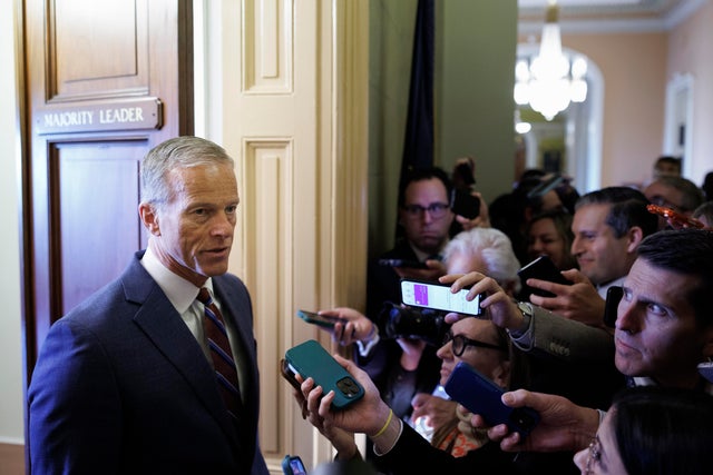 Senate Majority Leader John Thune speaks to reporters while walking to his office on Nov. 10, 2025, at the Capitol. 