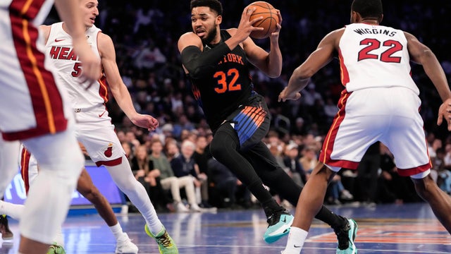 New York Knicks center Karl-Anthony Towns (32) drives past Miami Heat forward Nikola Jovic (5) during the first half of an NBA Cup basketball game, Friday, Nov. 14, 2025, in New York. 