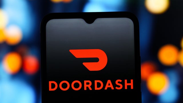 In this photo illustration, the DoorDash (Door Dash) logo is 