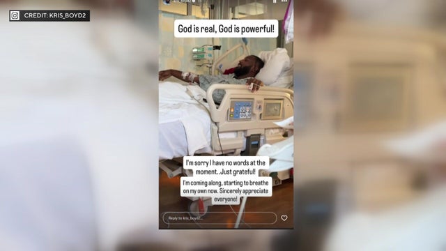 Kris Boyd in a hospital bed. Caption: "God is real, God is powerful! I'm sorry I have no words at the moment..Just grateful! I'm coming along, starting to breathe on my own now. Sincerely appreciate everyone!" 