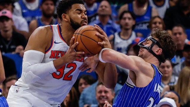 New York Knicks center Karl-Anthony Towns (32) makes his move to the basket defended by Orlando Magic forward Franz Wagner, right, during the second half of an NBA basketball game, Saturday, Nov. 22, 2025, in Orlando, Fla. 