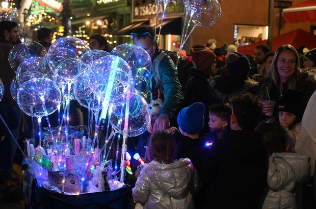 People pose for photos during a holiday event in Manayunk 