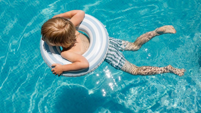 Little boy swimming in the pool 