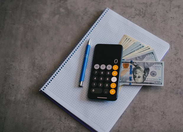 Mobile phone and money on grey background. Concept of payment and savings.