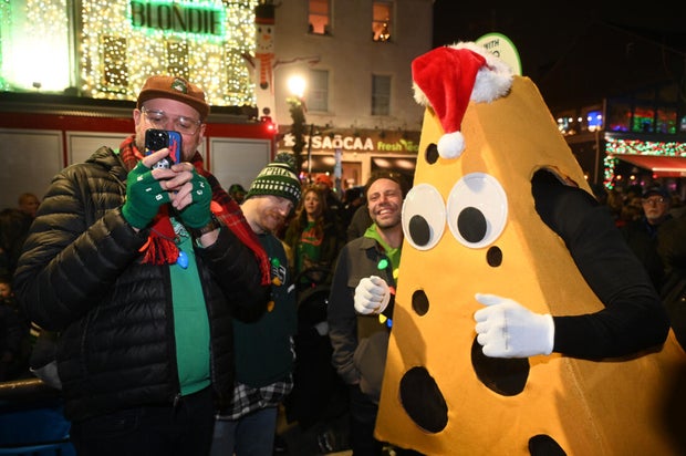 People pose for photos during a holiday event in Manayunk 