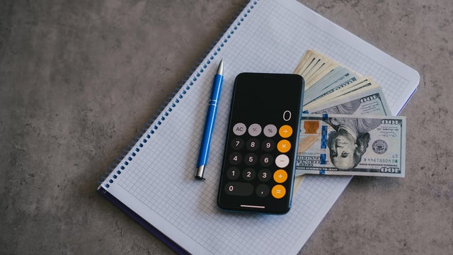 Mobile phone and money on grey background. Concept of payment and savings. 