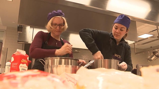 Two chefs stir large metal bowls in the food lab at West Chester University 