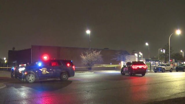 Close Up Shot Focused on Yellow Tape Showing Text Police Line Do Not Cross. Restricted Area of a Crime Scene. Bokeh Background with Flickering Siren Lights. Forensics Team Working on a Case 
