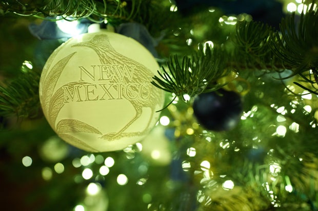 Ornaments hang from a Christmas tree in the Blue Room of the White House