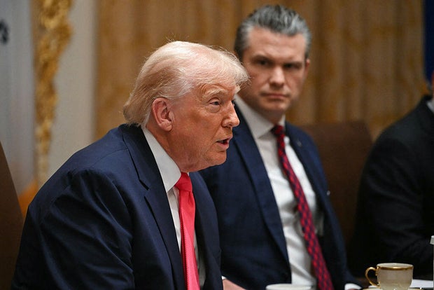 President Trump speaks alongside Defense Secretary Pete Hegseth during a Cabinet meeting at the White House in Washington, D.C., on Dec. 2, 2025. 