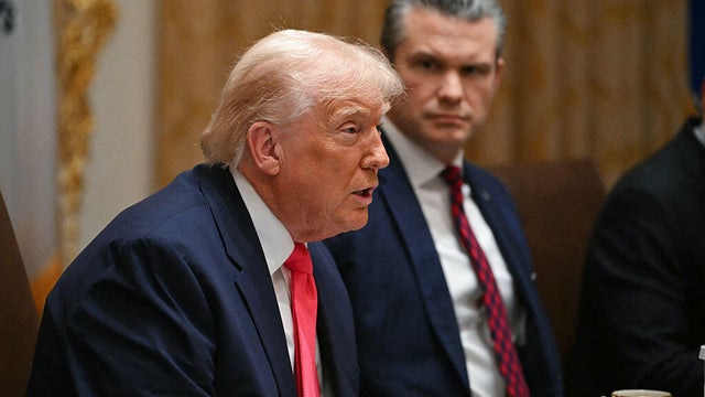 President Trump speaks alongside Defense Secretary Pete Hegseth during a Cabinet meeting at the White House in Washington, D.C., on Dec. 2, 2025. 