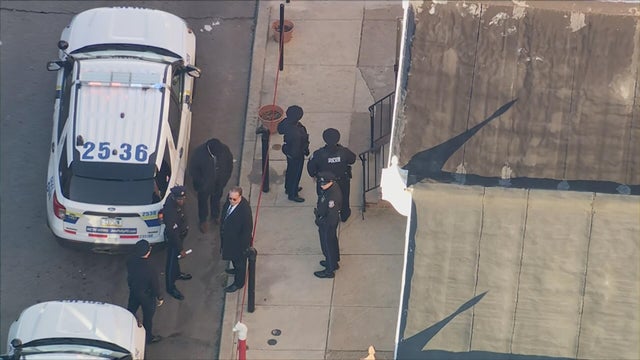 Close Up Shot Focused on Yellow Tape Showing Text Police Line Do Not Cross. Restricted Area of a Crime Scene. Bokeh Background with Flickering Siren Lights. Forensics Team Working on a Case 