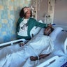 A 16-year-old lays in a hospital bed as his mother stands by his bedside 