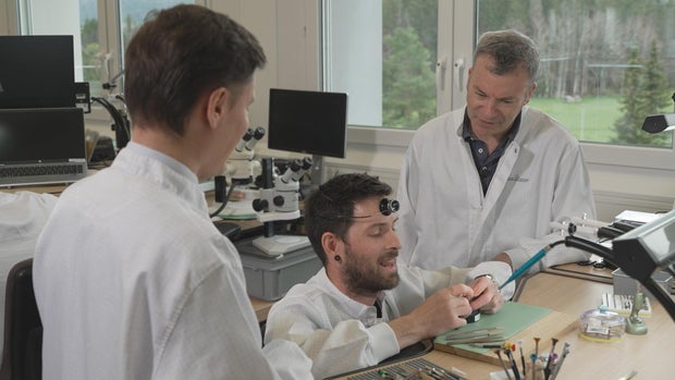 Jon Wertheim with Matthieu Sauret and a watchmaker at Jaeger LeCoultre