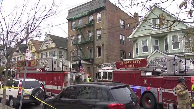 Jersey City apartment building with fire trucks outside 