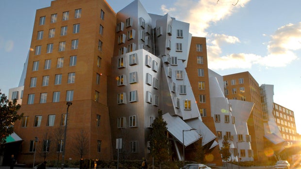 Pedestrians pass the Gehry designed Strata Center at the Mas