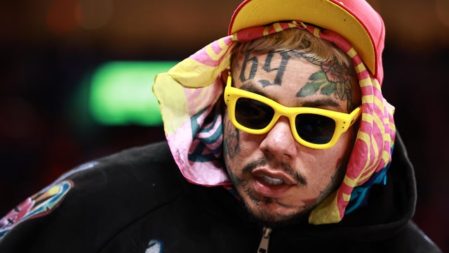 Tekashi 6ix9ine is seen during the second half of a game between the Miami Heat and the Cleveland Cavaliers at Kaseya Center on November 12, 2025 in Miami, Florida. 