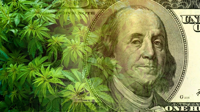 Cannabis leaf on the background of 100 dollar bill 