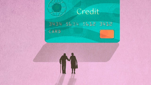 Silhouette of senior couple walking towards large credit card 