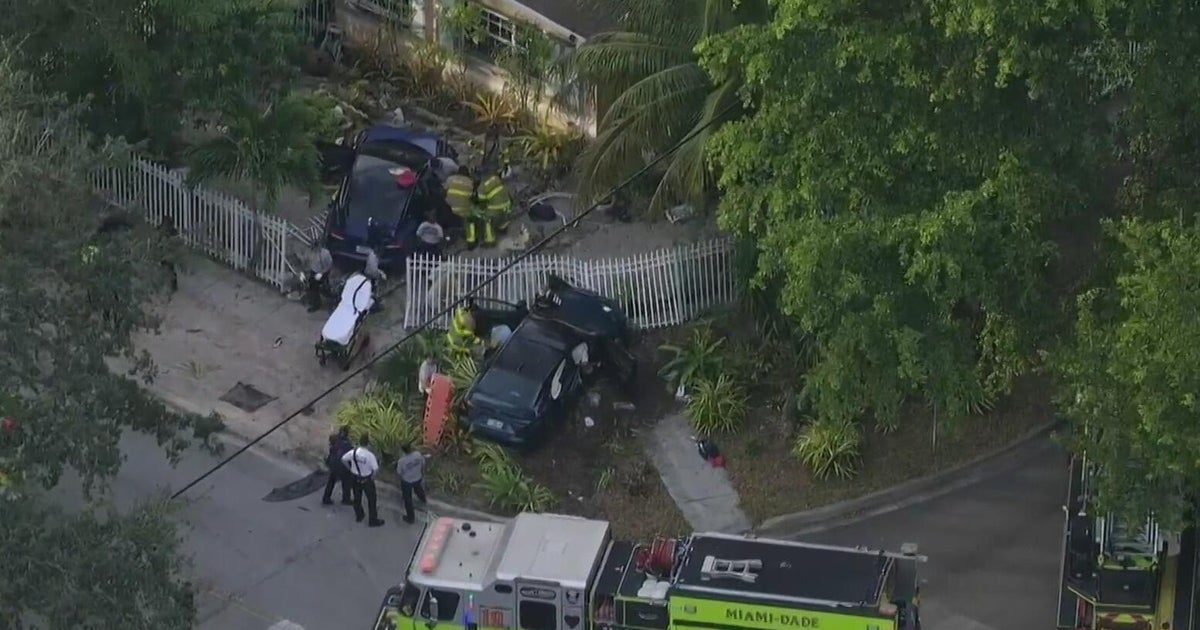 Four hospitalized after two‑car crash sends vehicles into North Miami yard