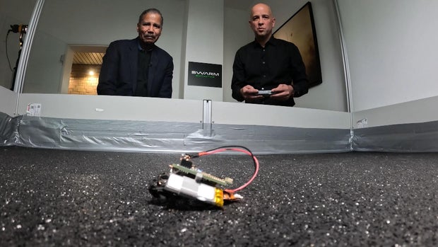 Bill Whitaker and SWARM Biotactics CEO Stefan Wilhelm with a cockroach