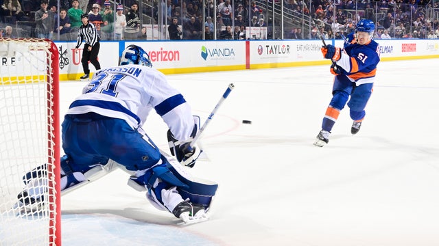 Emil Heineman #51 of the New York Islanders scores the game winning goal past Jonas Johansson #31 of the Tampa Bay Lightning during a shootout at UBS Arena on December 13, 2025 in Elmont, New York. 