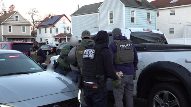 ICE agents at the driver's side door of a vehicle 