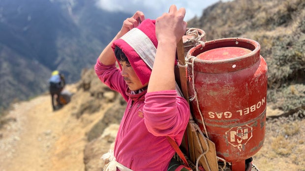 A porter carrying a drum of gas en route to Everest Base Camp. 