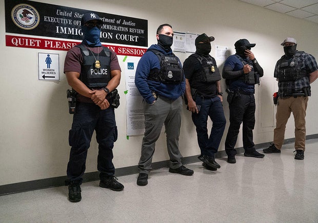 Federal law enforcement officers stand outside immigration courtrooms at the Javits Federal Building in New York on Nov. 21, 2025. 