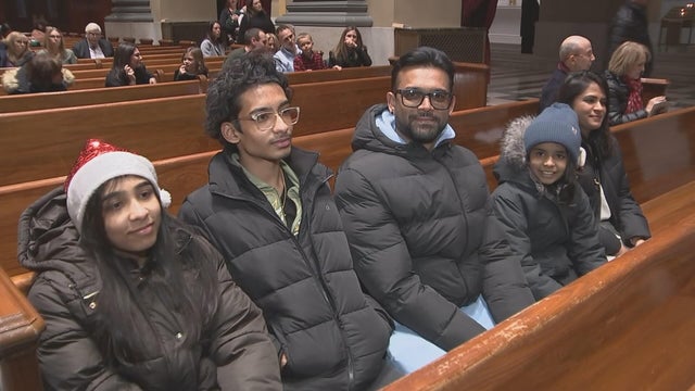 A family sits in a pew on Christmas Eve at the cathedral basilica in Philadelphia 