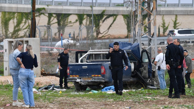 Israeli security forces inspect the scene where a vehicle was used by assailant in a suspected ramming and stabbing attack that killed two people in northern Israel according to Israeli authorities, in Afula 