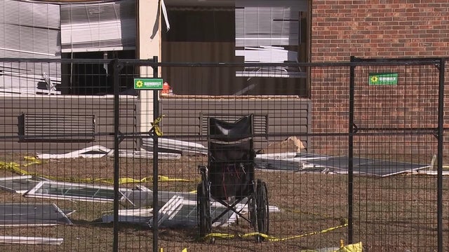A wheelchair is among the debris behind a fence on the site of the explosion in Bristol 