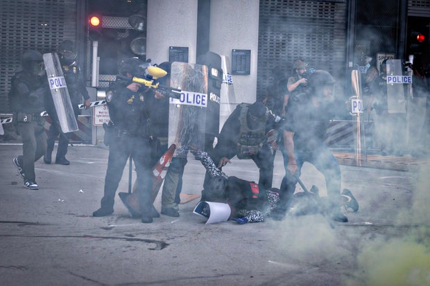 Demonstrators protest outside the Edward R. Roybal Federal Building and the Metropolitan Detention Center in response to ICE raids 