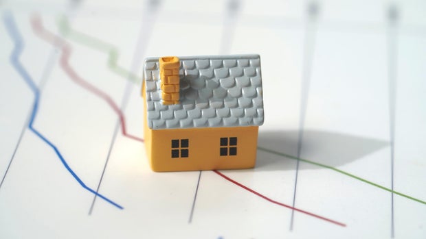 Housing and graph concept , with toy house 