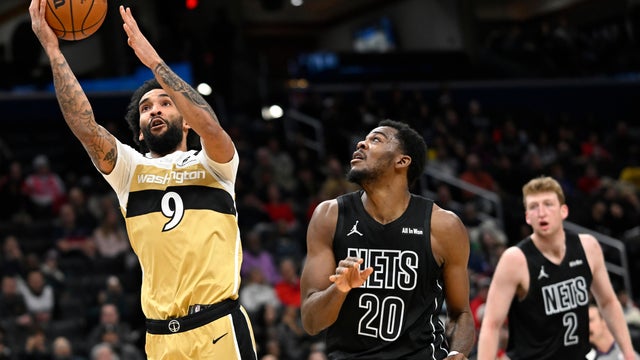 Washington Wizards forward Justin Champagnie (9) looks to shoot a basket against Brooklyn Nets center Day'Ron Sharpe (20) during the first half of an NBA basketball game, Friday, Jan. 2, 2026, in Washington. 