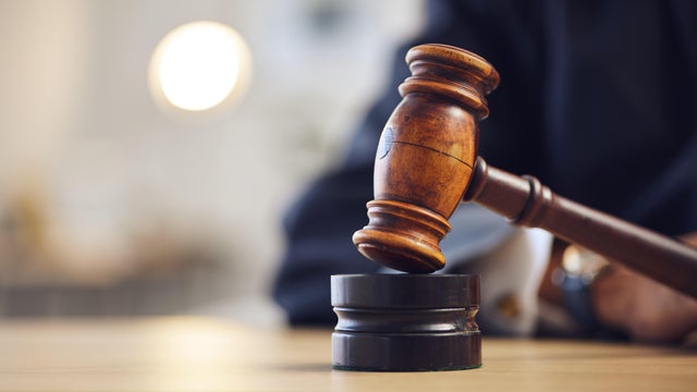 Law, judge and closeup of lawyer with gavel for justice, court hearing and legal trial for magistrate. Government, attorney career and zoom of desk for investigation, criminal case and verdict order 