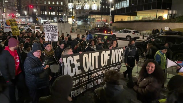 Protesters march through NYC with an "ICE Out of NYC" banner. 