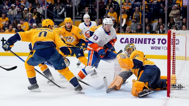 Juuse Saros #74 of the Nashville Predators makes a save against Mathew Barzal #13 of the New York Islanders during an NHL game at Bridgestone Arena on January 8, 2026 in Nashville, Tennessee. 