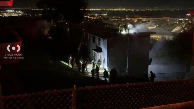 Firefighters surround a building 