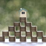 Mortgage,Model house and stack of coins money on natural green background,Business investment and real estate concept 