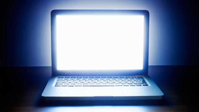 Laptop with glowing screen. 