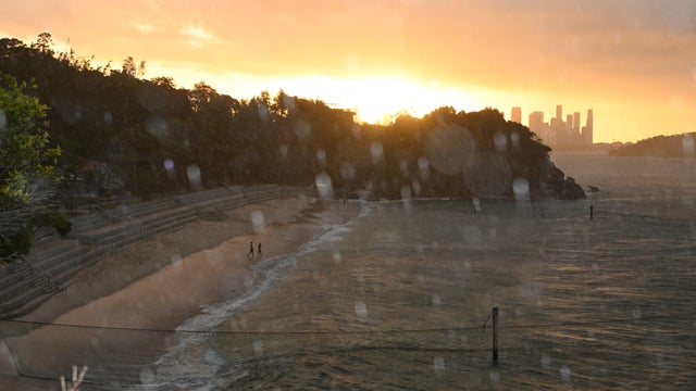 A view of rainfall over Shark Beach at sunset 