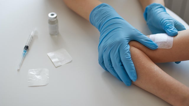 doctor applies a patch after the vaccination. Treatment of the injection. Close-up. Vaccination. The injection. 