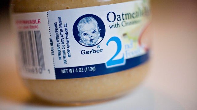 A jar of Gerber oatmeal baby food is arranged for a photogra 