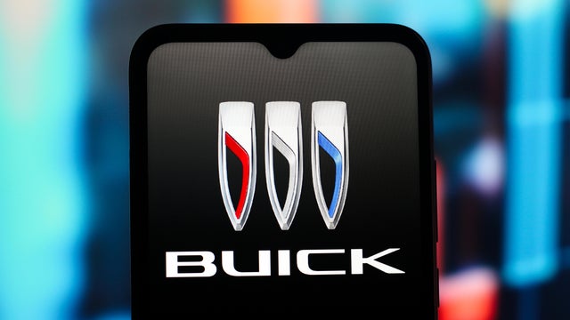 In this photo illustration, the Buick logo is seen displayed 