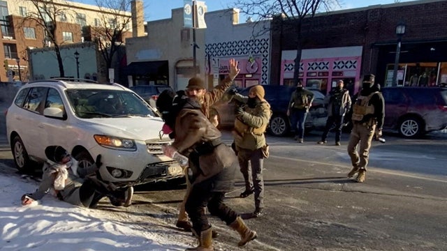 Law enforcement officers and protesters before the shooting of Alex Pretti in Minneapolis 