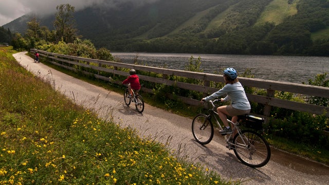 Mom and son biking along the Franconia Notch Bike Trail. 