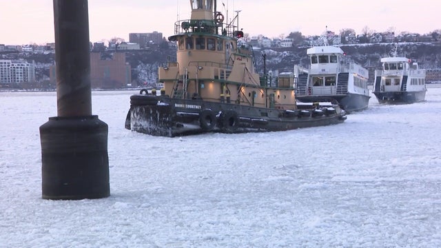 A ferry navigates an icy NYC river 