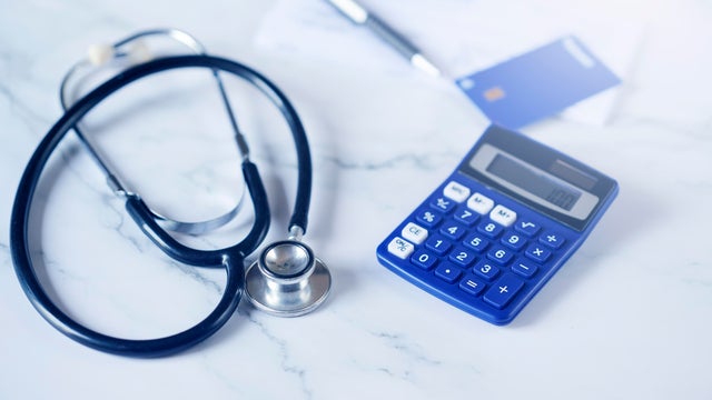 Blue credit card next to stenoscope and calculator 