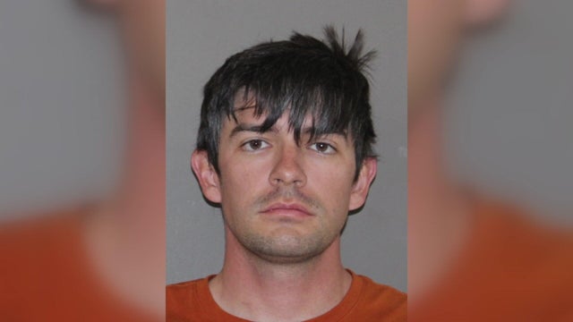 Simple Conceptual Image of Silver Handcuffs on Blue Surface 